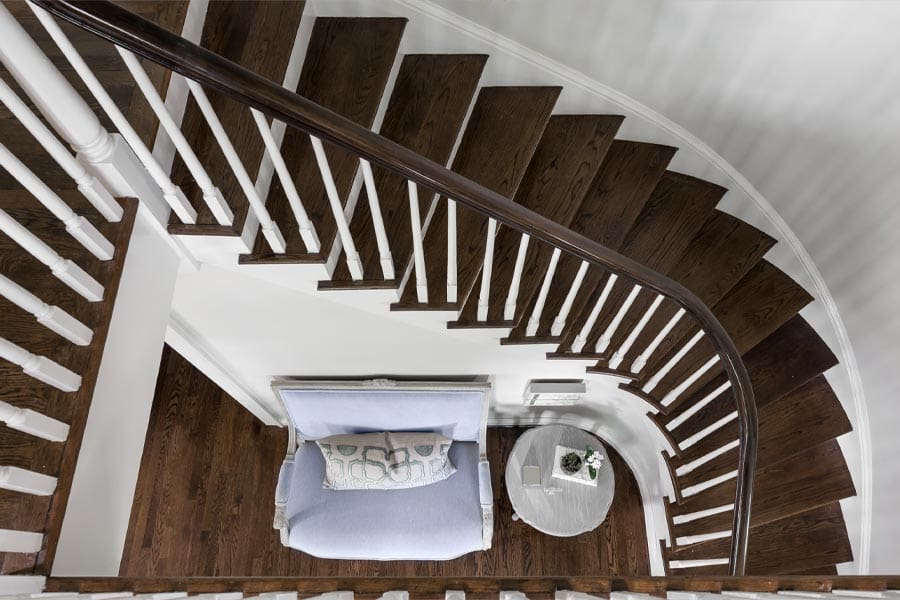 Curved staircase in luxury home with white spokes near Nashville, Tennessee