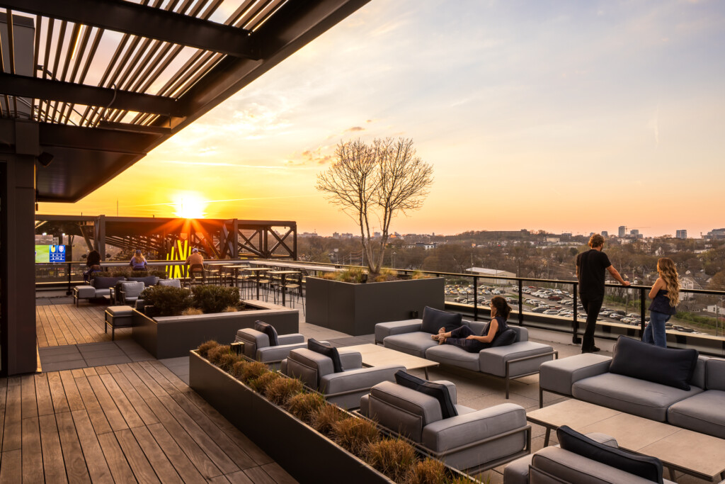 445 Park Commons - GEODIS - Rooftop terrace with contemporary lounge seating, pergola, and panoramic cityscape at golden hour