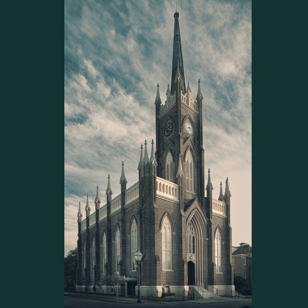 Tall brick Gothic Revival church with pointed spire, ornate stonework, arched windows, and flanking turrets against cloudy sky